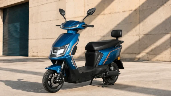 Blue seated electric scooter with a step-through frame outside a concrete building
